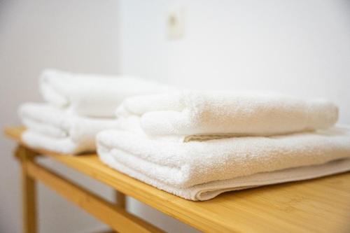 a pile of white towels sitting on a table at OTIUM living in Volos