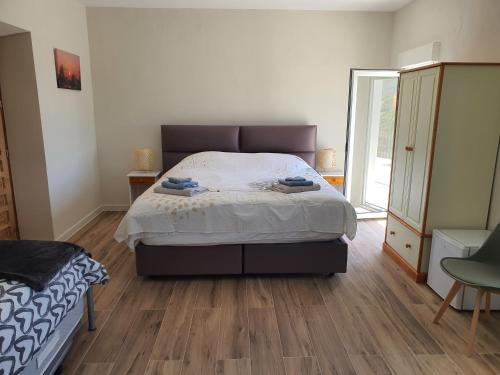 a bedroom with a bed and a wooden floor at Casa Nuestro Sueño in Oria