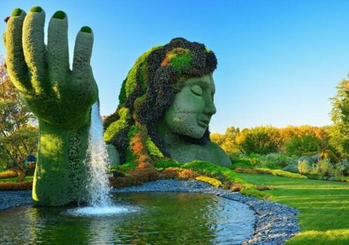 a statue of a woman with a hand in a fountain at HoMa Homestay Hotel by Olympic Stadium Montreal Auberge-Hostel in Montréal
