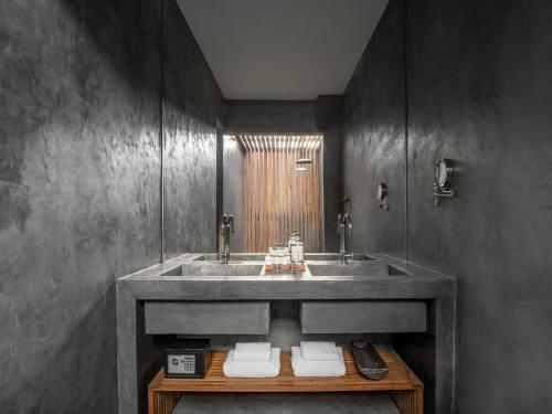 a bathroom with a sink and a mirror at KA BRU Beach Boutique Hotel in Barra Grande