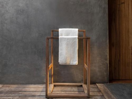 a towel on a towel rack in a room at KA BRU Beach Boutique Hotel in Barra Grande