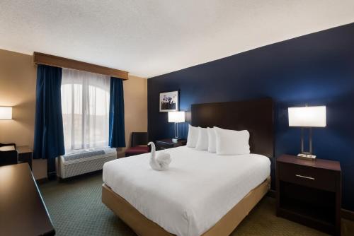 a hotel room with a large bed and a window at Best Western Springfield in Springfield