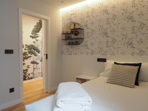 a bedroom with a bed and a bird cage on the wall at Museo Evolución - Apartamentos Burgos Deluxe in Burgos