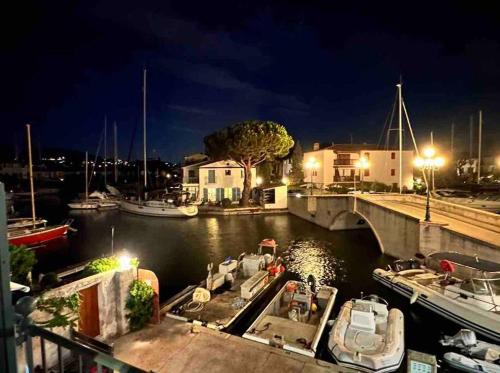 a group of boats docked in a marina at night at Pura Vida, Port Grimaud in Grimaud