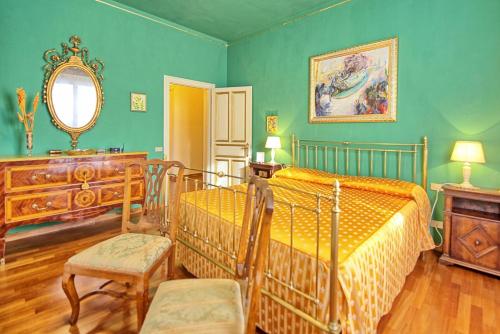 a bedroom with two beds and a mirror at Villa Lauretana by PosarelliVillas in Torrita di Siena