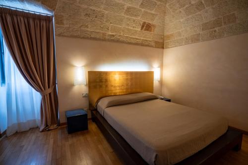 Ένα ή περισσότερα κρεβάτια σε δωμάτιο στο San Tommaso Hotel