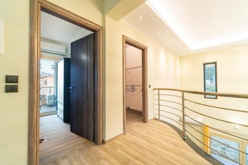 a hallway with a door and a staircase in a house at The Mountain Villa in Aleimmatádes