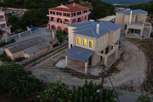 an overhead view of a large house with yellow windows at The Mountain Villa in Aleimmatádes