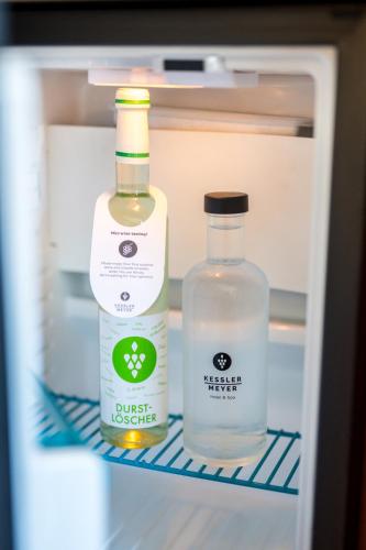 two bottles of milk and a bottle of water in a refrigerator at Moselromantik Hotel Kessler Meyer in Cochem