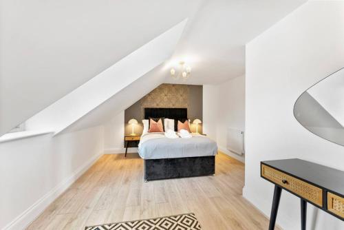 a white bedroom with a bed and a desk at Large 5 Bedroom House in the Cotswolds - Garden in Moreton in Marsh