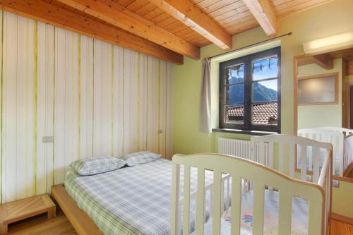 a small bedroom with a bed and a window at Casa Pollicina in Margno