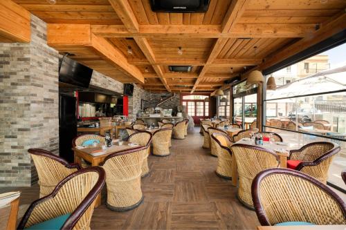 a row of tables and chairs in a restaurant at Ushuaia Playa Xemxija Boutique Hotel in St Paul's Bay