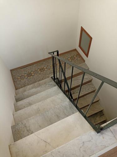 a set of stairs with a metal railing and a mirror at BB Orvieto in Orvieto