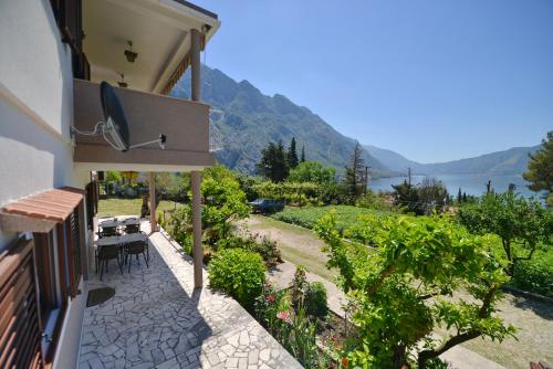 a house with a patio with a view of the water at B & M Apartments in Kotor
