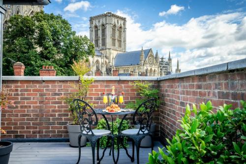 a patio with a table and chairs on a brick wall at 11 Stonegate Court in York