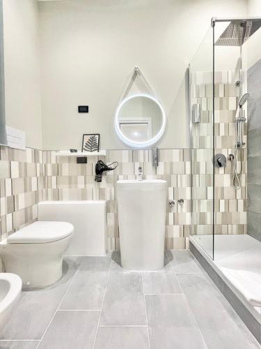 a bathroom with a toilet and a sink and a mirror at Regina Elena Rooms in Pescara