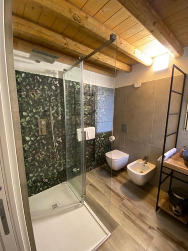 a bathroom with a shower with a toilet and a sink at Elva Suite House in Chioggia