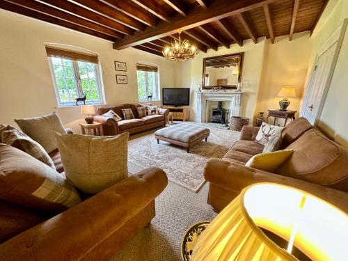 a large living room with couches and a fireplace at Country Retreat in York