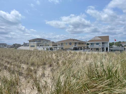 a row of houses on a beach with tall grass at The White Sands Resort and Spa in Point Pleasant Beach
