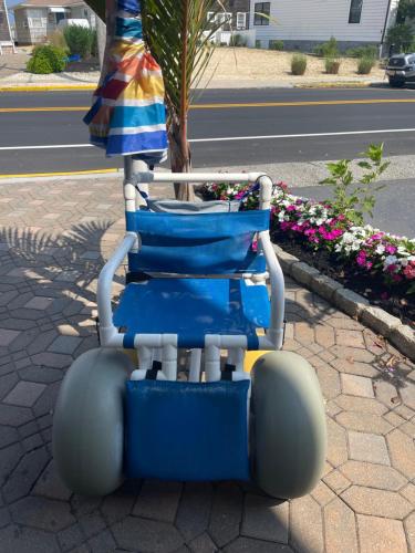 a blue wheelchair sitting on the side of a street at The White Sands Resort and Spa in Point Pleasant Beach
