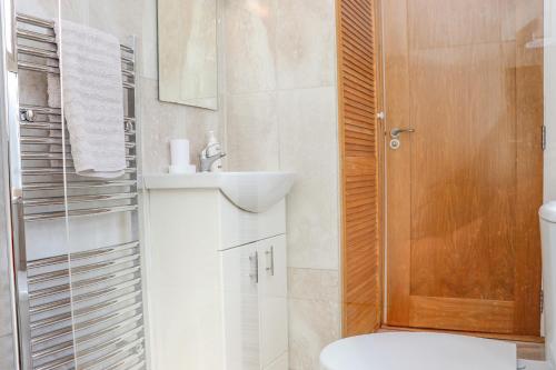 La salle de bains est pourvue de toilettes, d'un lavabo et d'un miroir. dans l'établissement An Teachain, à Ballynabola