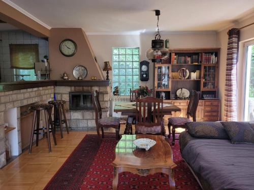 a living room with a couch and a table at Nature Guest House Sarajevo in Sarajevo