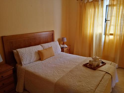 um quarto com uma cama grande e uma bandeja em Casa Palmés em Valles de Ortega