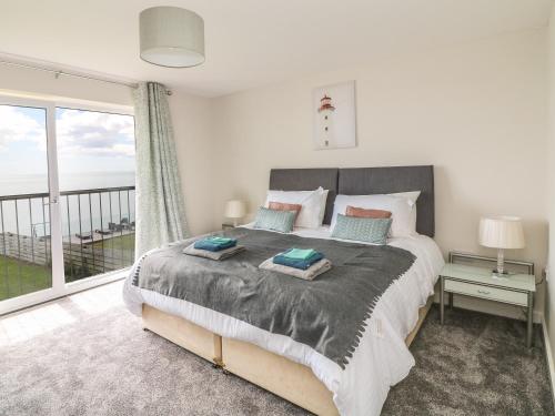 a bedroom with a bed with a view of the ocean at Beach House in Gorey