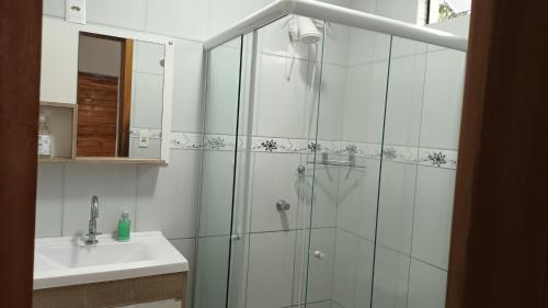 a bathroom with a shower and a sink at Suíte privativa 11km vila germânica in Blumenau