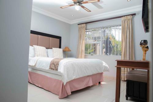 a bedroom with a large bed and a window at The Afropolitan in Johannesburg
