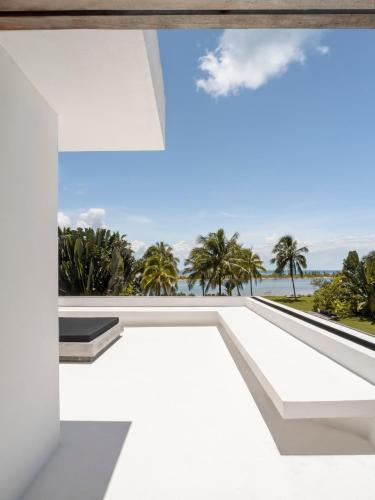 a white house with a view of the ocean at KA BRU Beach Boutique Hotel in Barra Grande