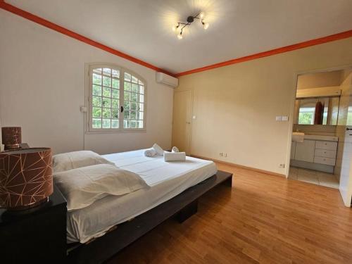 a bedroom with a large bed and a window at L'Inattendue in Castelnau-le-Lez