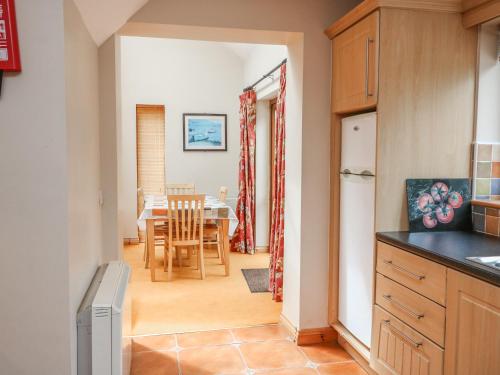 a kitchen with a table and a dining room at 13 Sneem Leisure Village in Sneem