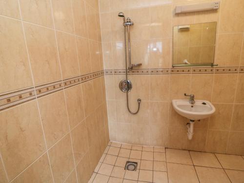 a bathroom with a sink and a mirror at 13 Sneem Leisure Village in Sneem