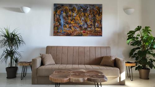 a living room with a couch and a painting on the wall at Kallistis Beach House in Monolithos