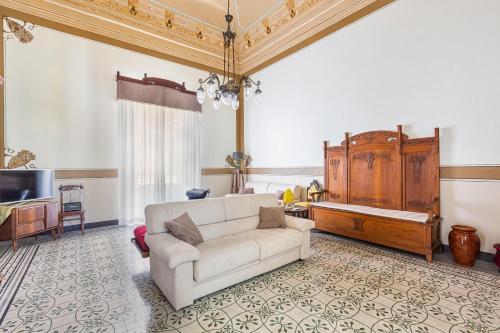 a living room with a couch and a tv at Bianco Liberty by BarbarHouse in Trepuzzi