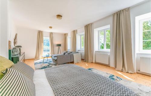 a bedroom with a bed and a living room at Lovely Apartment In Persenbeug-gottsdorf With House A Panoramic View in Persenbeug-Gottsdorf