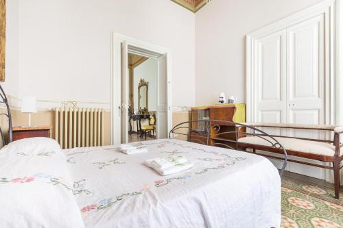 a white bedroom with a bed and a mirror at Bianco Liberty by BarbarHouse in Trepuzzi