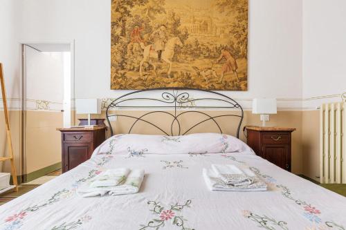 a bedroom with a bed with two towels on it at Bianco Liberty by BarbarHouse in Trepuzzi