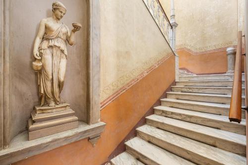 a statue on the side of a building with stairs at Bianco Liberty by BarbarHouse in Trepuzzi