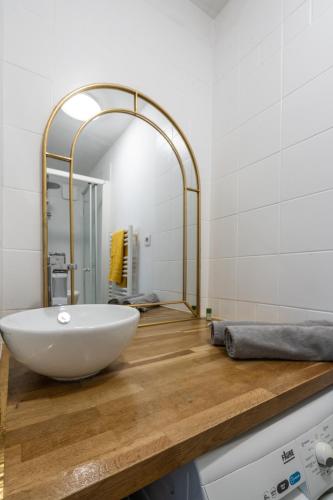 une salle de bain avec un lavabo blanc et un miroir dans l'établissement F3 Terrasse La défense, à Courbevoie
