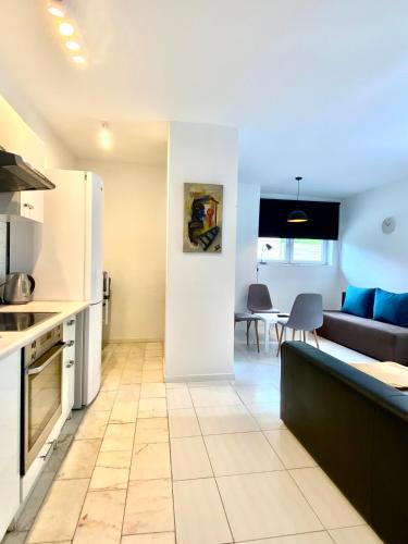 a kitchen and living room with a couch and a table at Familly Apartament 2 in Międzyzdroje