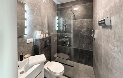 a bathroom with a shower and a toilet and a sink at Nice Home In Stare Sady With Kitchen in Stare Sady