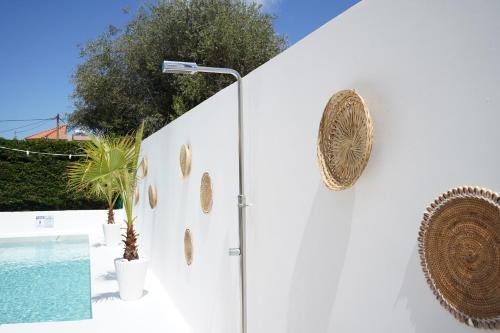 a white wall with gold decorations on it at Villa Pastida - Private Pool and Jacuzzi in Pastida