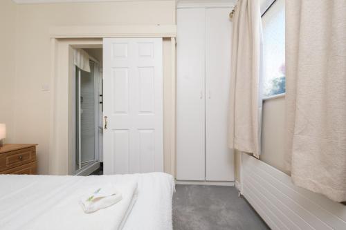 a bedroom with a white bed and a window at Four Seasons B&B in Galway