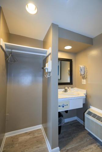 a bathroom with a shower and a sink at The White Sands Resort and Spa in Point Pleasant Beach