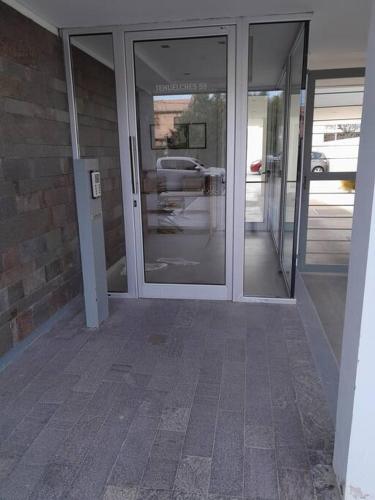 an entrance to a building with glass doors at Simonetta in Puerto Madryn