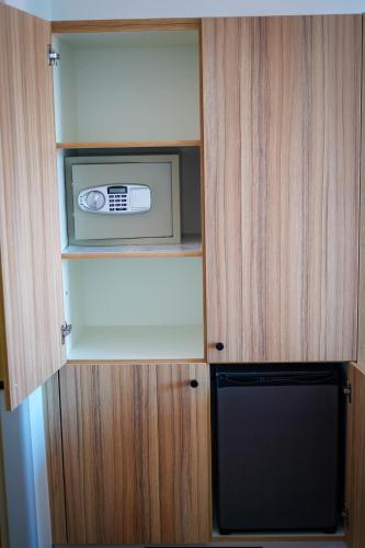 a kitchen with a microwave in a cupboard at STEELHOUSE Hotel in Třinec