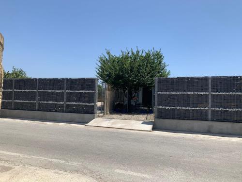 a fence on the side of a road at Casa ILEANA in Sanlúcar de Barrameda