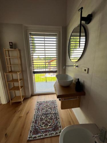 a bathroom with a sink and a large window at CASA VOLA in Cuneo